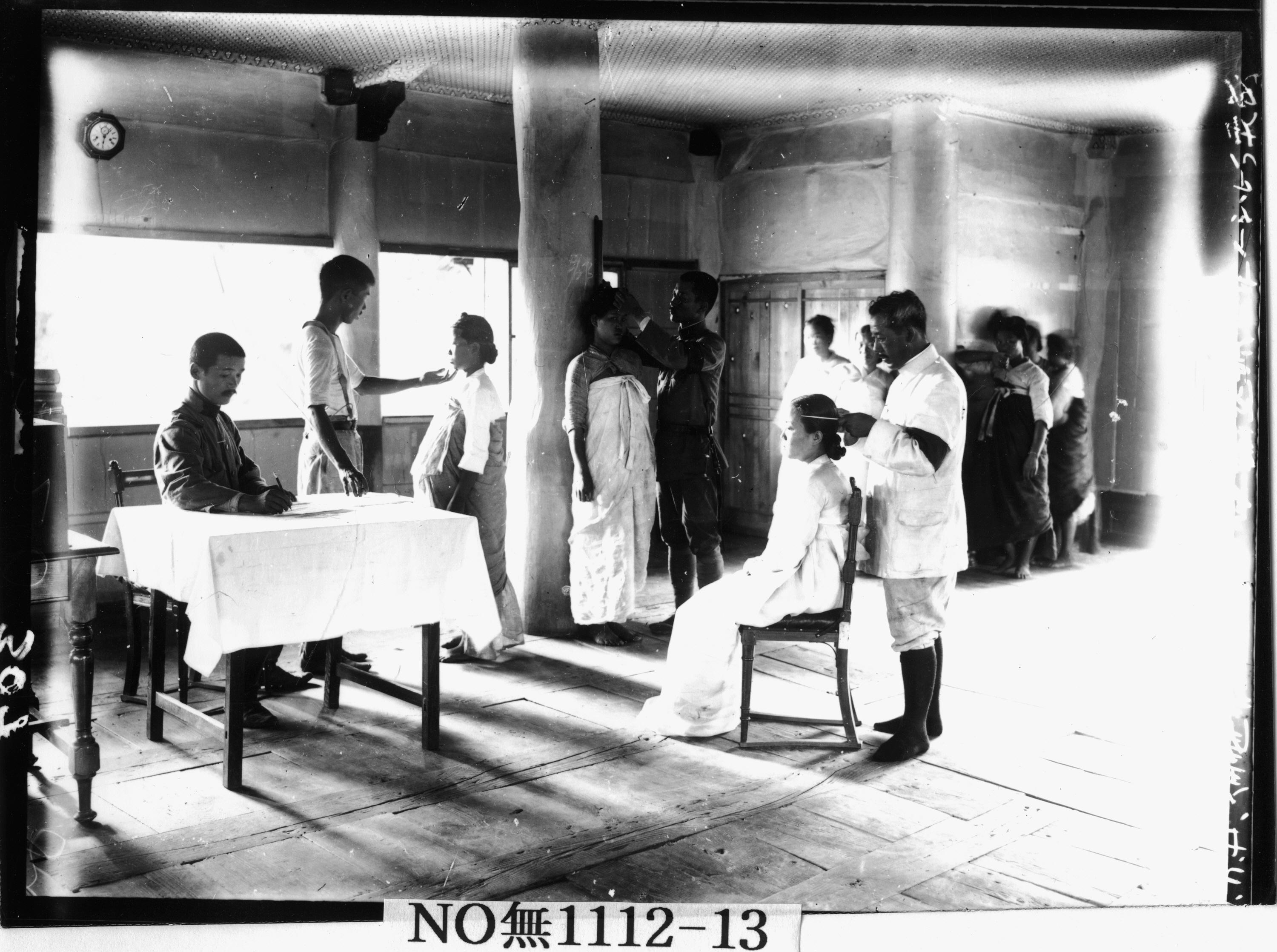 Colonial officials measuring Koreans for anthropometric research.